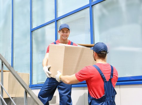 Team member loading a van safely with protective blankets