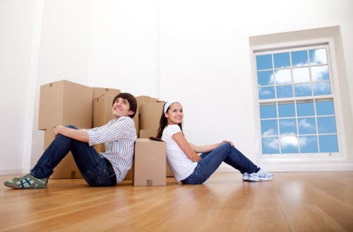 Packed office furniture and boxed IT equipment for relocation