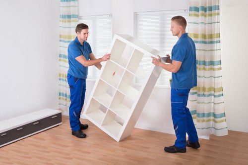 Experienced movers positioning a piano in a Coulsdon property